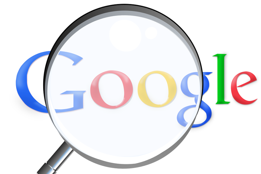 google icon seen through a magnifying glass