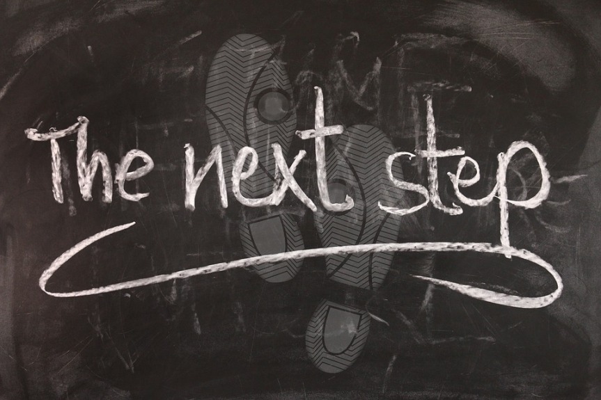 image showing the words 'the next step' chalked onto a blackboard