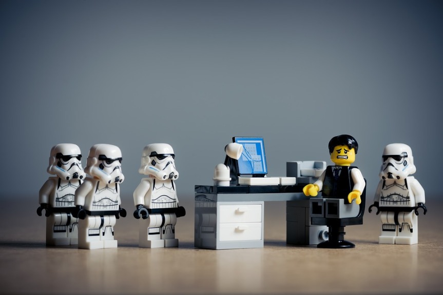 image showing lego figure sat at desk surrounded with lego stormtroopers, making him feel guilty